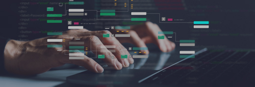 Hände tippen auf Laptop-Tastatur mit eingeblendetem Programmcode